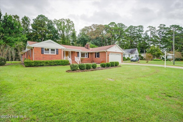 ranch-style home featuring a front lawn, covered porch, and a garage