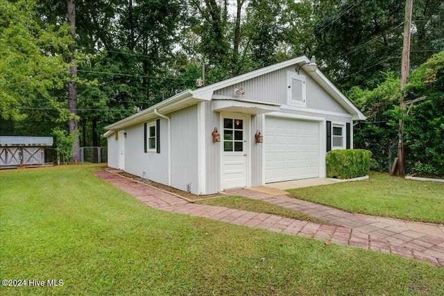 garage featuring a lawn