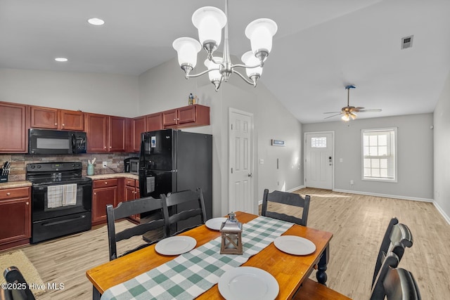 dining space with high vaulted ceiling, ceiling fan with notable chandelier, and light wood-type flooring