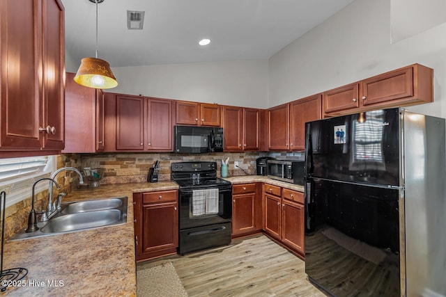 kitchen with decorative light fixtures, sink, backsplash, high vaulted ceiling, and black appliances