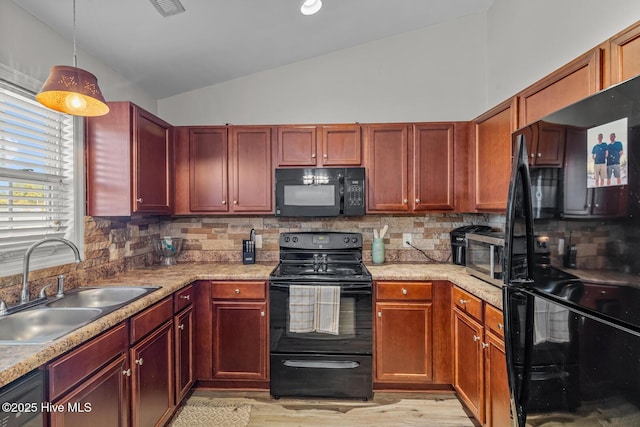 kitchen with black appliances, lofted ceiling, decorative backsplash, sink, and hanging light fixtures