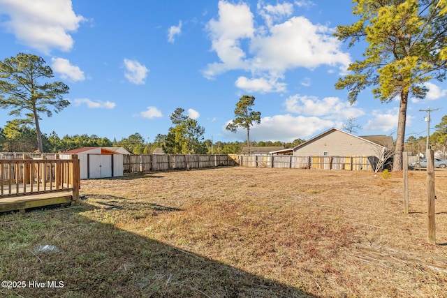 view of yard featuring a storage shed and a deck