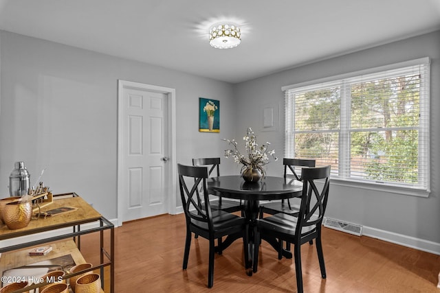 dining space featuring wood-type flooring