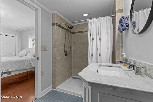 bathroom featuring curtained shower, tile patterned flooring, vanity, and ornamental molding