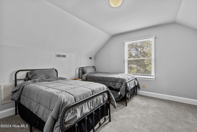 bedroom featuring light colored carpet and lofted ceiling