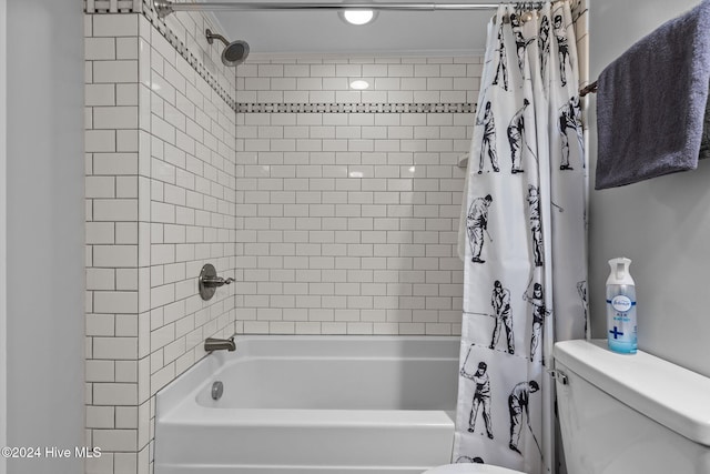 bathroom featuring shower / bath combo and toilet