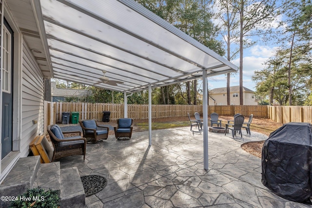 view of patio / terrace with a fire pit, ceiling fan, and area for grilling