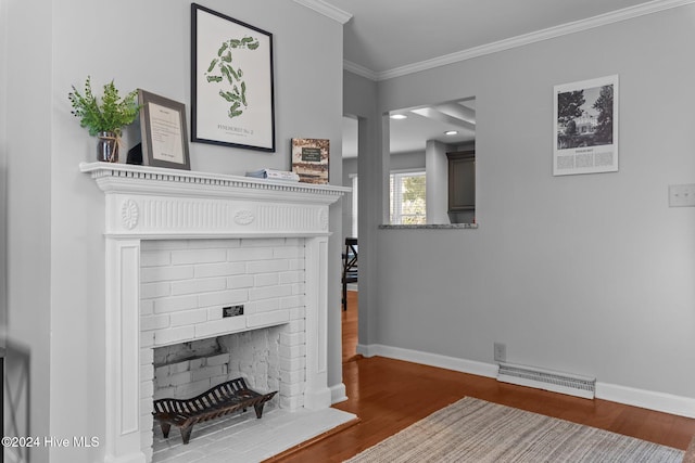 living room featuring hardwood / wood-style floors, ornamental molding, and a fireplace