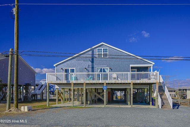 back of property with a carport and a wooden deck