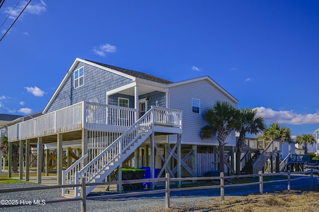 rear view of property featuring covered porch