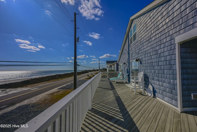 wooden terrace with a water view and a beach view