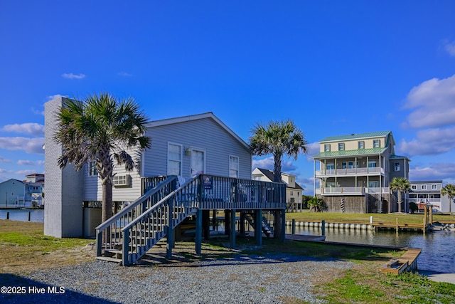 back of house featuring a deck with water view