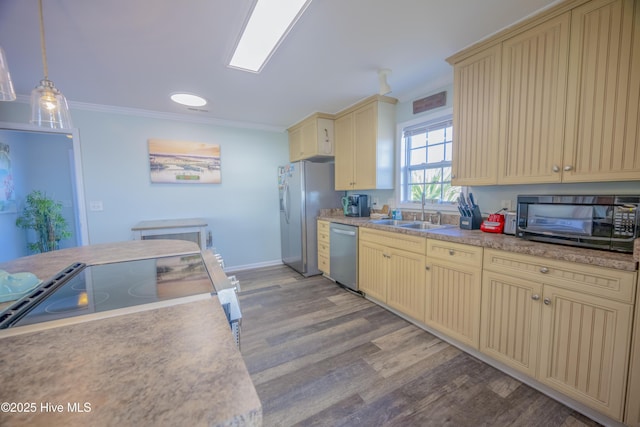 kitchen featuring sink, light wood-type flooring, decorative light fixtures, appliances with stainless steel finishes, and ornamental molding