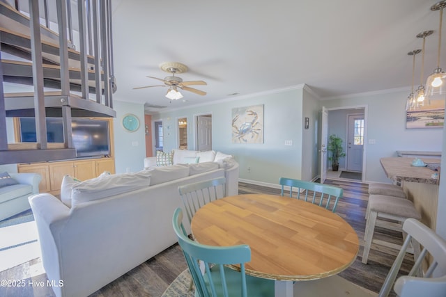 dining space featuring dark hardwood / wood-style floors, ceiling fan, and crown molding