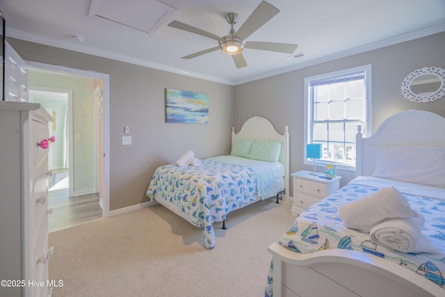 carpeted bedroom with ceiling fan and ornamental molding