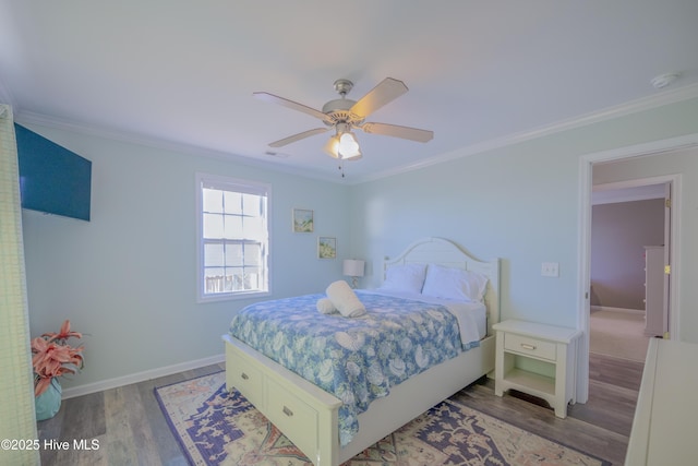 bedroom featuring ceiling fan, wood-type flooring, and crown molding