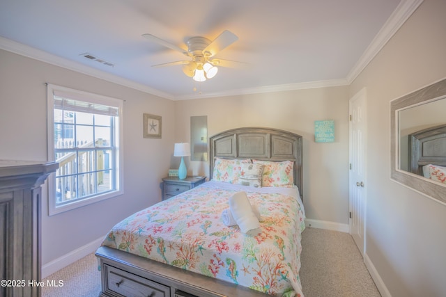 carpeted bedroom with ceiling fan and crown molding