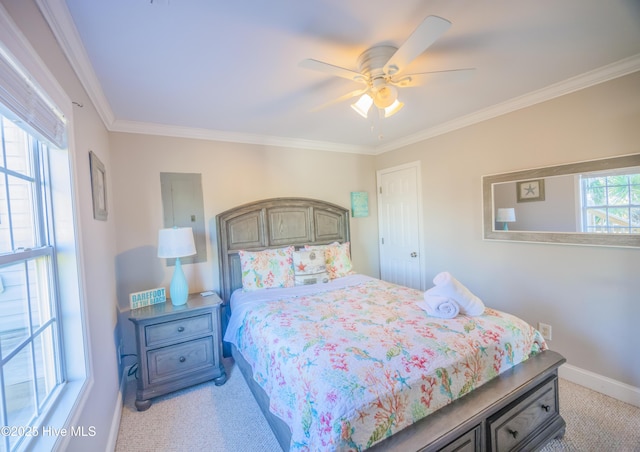 bedroom with ceiling fan, light colored carpet, and crown molding