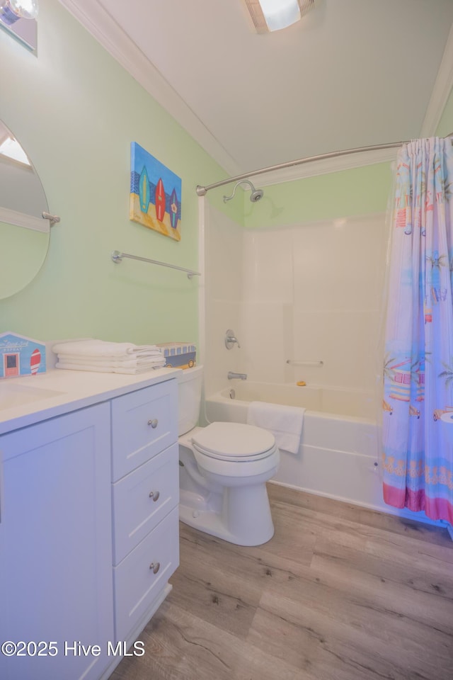 full bathroom with vanity, hardwood / wood-style flooring, toilet, ornamental molding, and shower / bathtub combination with curtain