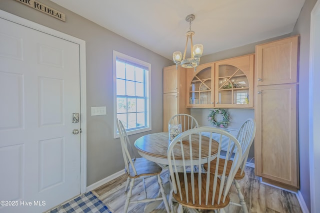 dining room featuring light hardwood / wood-style floors and an inviting chandelier