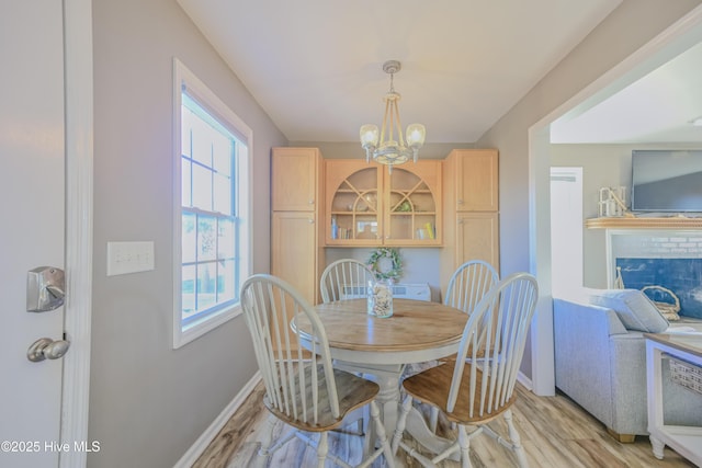 dining space with a notable chandelier and light wood-type flooring