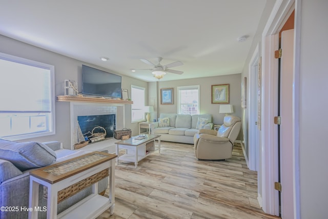 living room featuring ceiling fan and light wood-type flooring