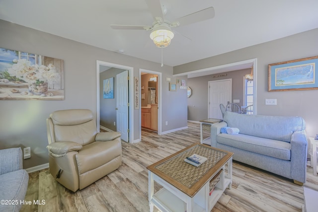 living room with ceiling fan and light wood-type flooring