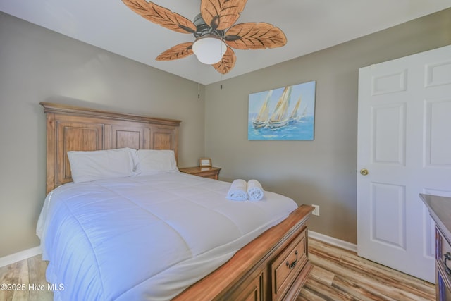 bedroom with ceiling fan and light hardwood / wood-style flooring