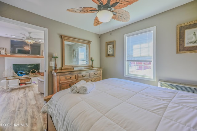 bedroom with light hardwood / wood-style flooring and ceiling fan