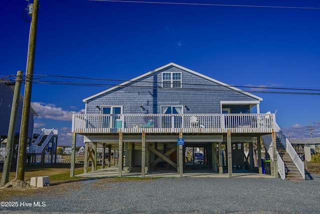 exterior space with a carport and a wooden deck