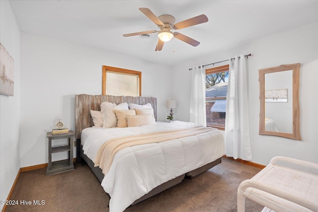 bedroom featuring dark colored carpet and ceiling fan