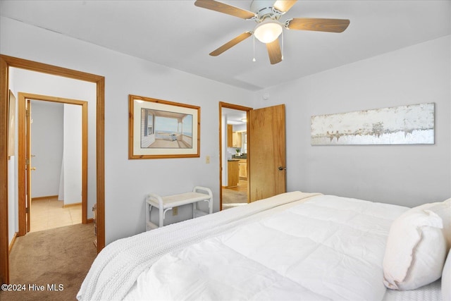 bedroom featuring light colored carpet and ceiling fan