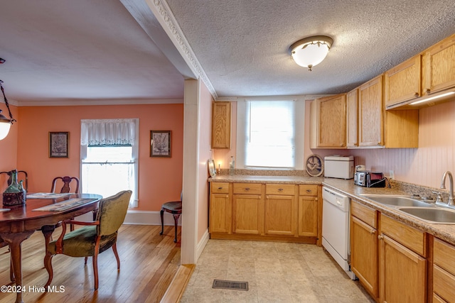 kitchen with sink, white dishwasher, light hardwood / wood-style floors, a textured ceiling, and ornamental molding