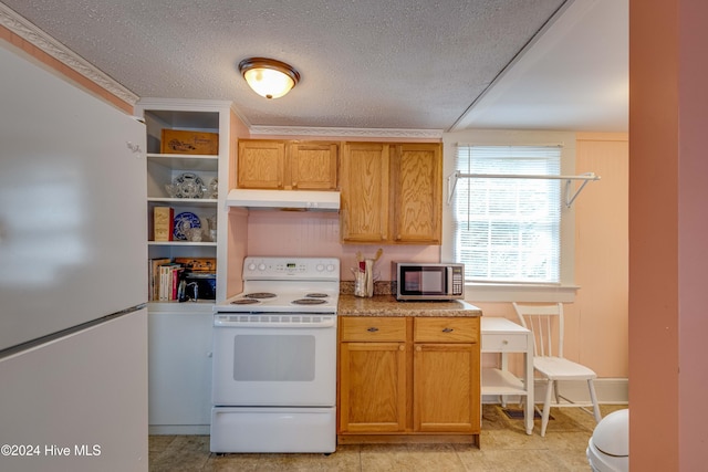 kitchen featuring a textured ceiling, white appliances, and light tile patterned floors