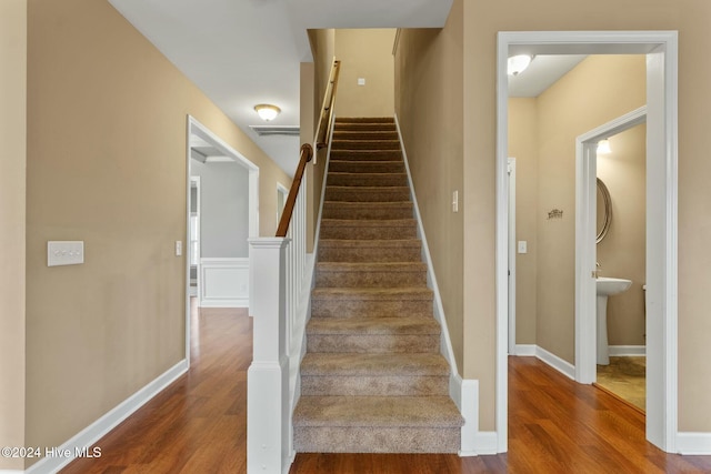 stairs featuring hardwood / wood-style flooring