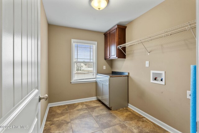 clothes washing area with cabinets and hookup for a washing machine