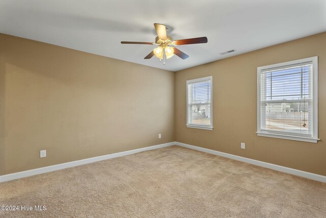 carpeted empty room with ceiling fan