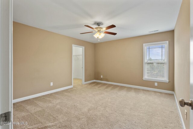 carpeted empty room with ceiling fan