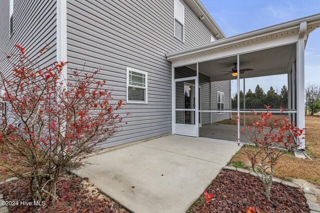 view of patio / terrace with a sunroom and ceiling fan