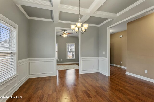 unfurnished dining area with coffered ceiling, an inviting chandelier, crown molding, beamed ceiling, and hardwood / wood-style floors