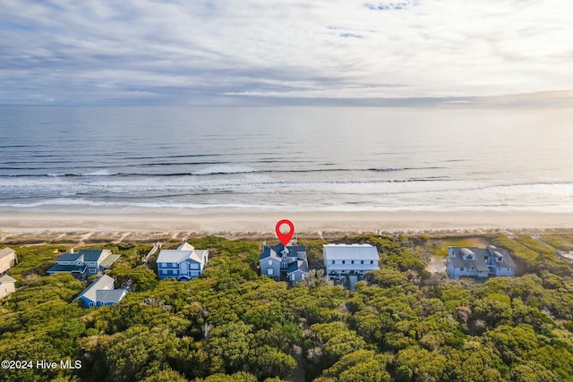 birds eye view of property featuring a water view and a beach view