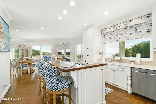 kitchen with a kitchen island, decorative light fixtures, dishwasher, dark hardwood / wood-style floors, and white cabinetry