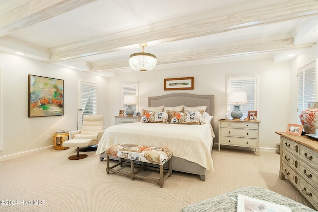 bedroom with beam ceiling, light colored carpet, and an inviting chandelier