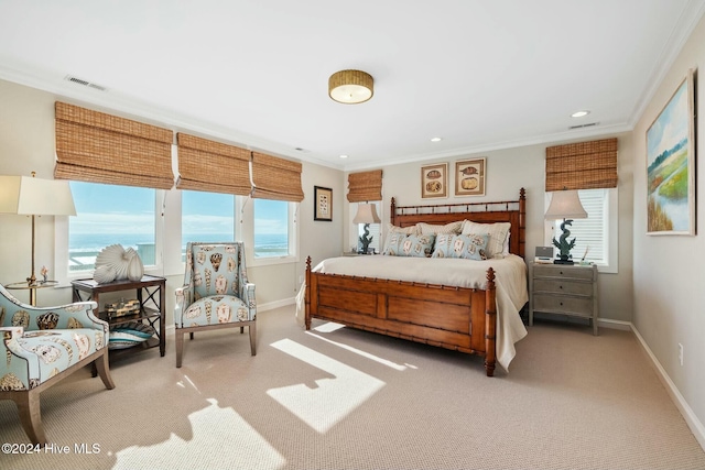 carpeted bedroom with multiple windows, a water view, and ornamental molding