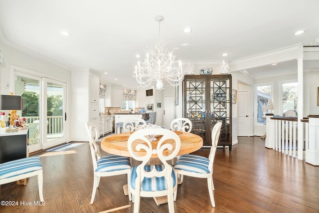 dining room with a notable chandelier, crown molding, and dark wood-type flooring