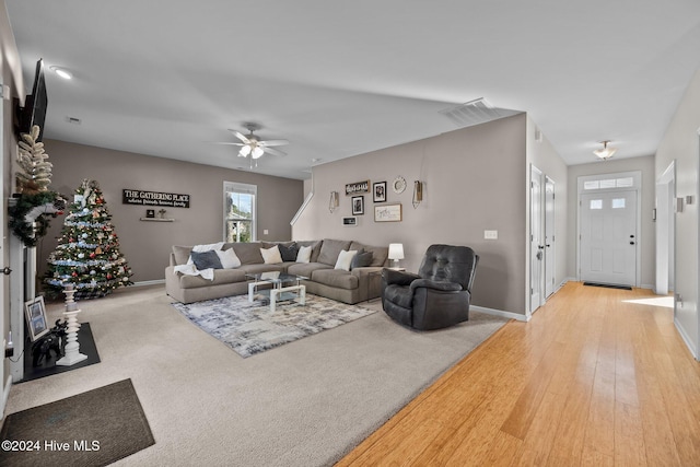 living room with ceiling fan and light hardwood / wood-style floors