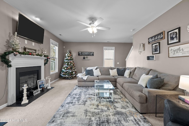 carpeted living room with ceiling fan