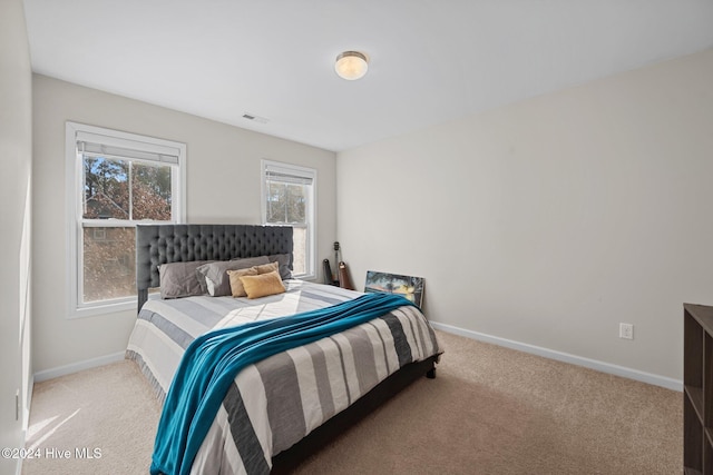 bedroom with light colored carpet