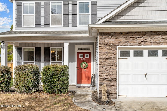 view of exterior entry featuring a garage