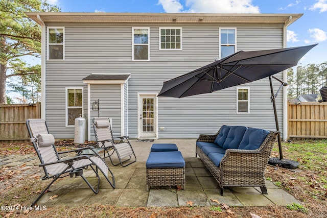 rear view of property featuring a patio and an outdoor hangout area